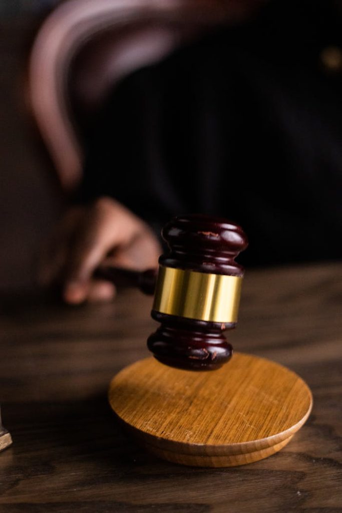 Close-up of a judges gavel on a wooden block, symbolizing justice and law.